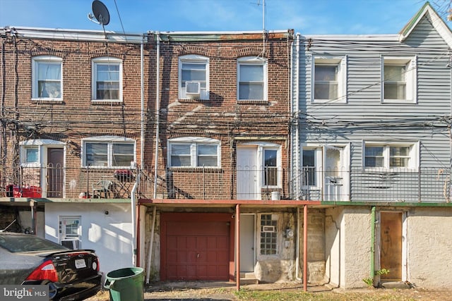 townhome / multi-family property featuring a balcony and a garage