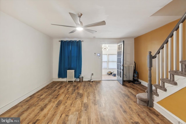 foyer entrance featuring ceiling fan, wood-type flooring, and radiator