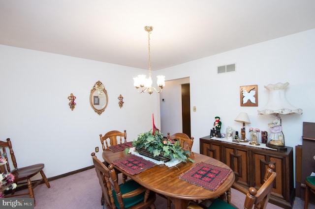 carpeted dining area with a notable chandelier