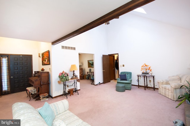 carpeted living room with beam ceiling and high vaulted ceiling