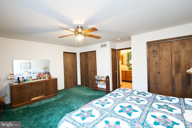 bedroom featuring ceiling fan, dark carpet, connected bathroom, and multiple closets