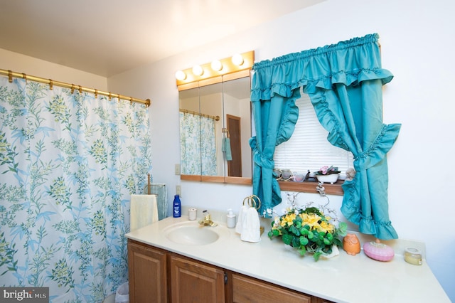 bathroom with vanity and curtained shower