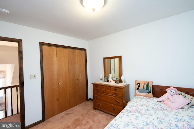 bedroom featuring light carpet and a closet