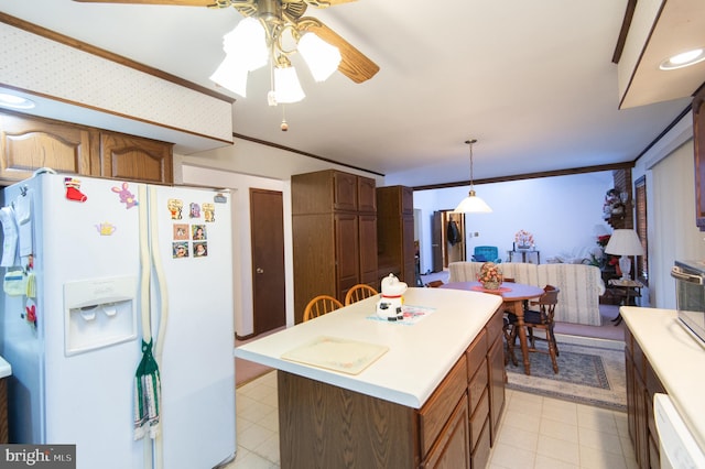 kitchen featuring ceiling fan, a center island, hanging light fixtures, crown molding, and white appliances