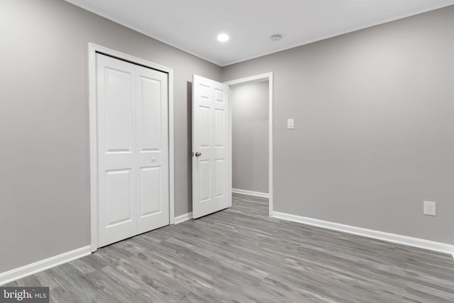 unfurnished bedroom featuring a closet and light hardwood / wood-style flooring