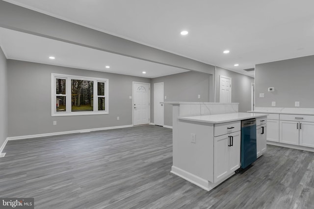 kitchen with hardwood / wood-style floors, dishwasher, a center island, and white cabinets