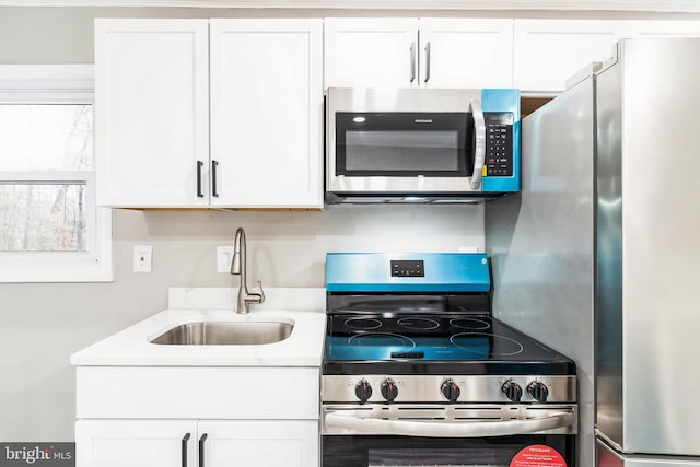 kitchen featuring white cabinetry, appliances with stainless steel finishes, and sink