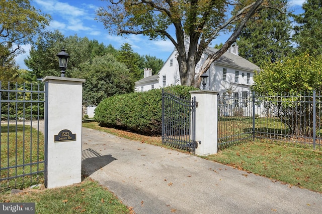 view of gate with a yard