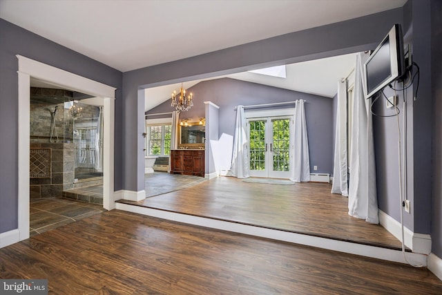1523 Johnnys Way, West Chester, PA 19382 - unfurnished living room with french doors, a baseboard heating unit, wood finished floors, vaulted ceiling, and baseboards