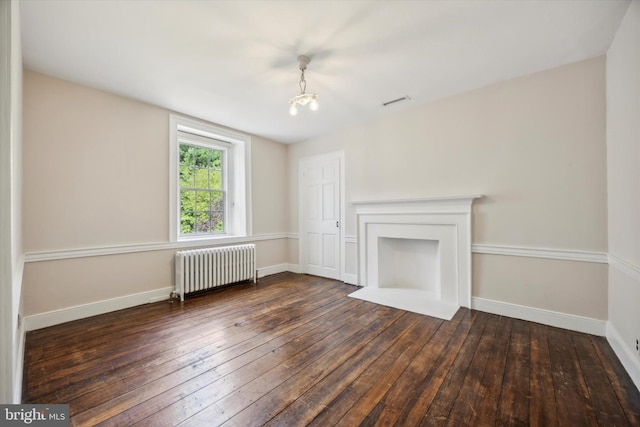 1523 Johnnys Way, West Chester, PA 19382 - unfurnished living room featuring radiator heating unit, dark wood-style flooring, baseboards, and a chandelier