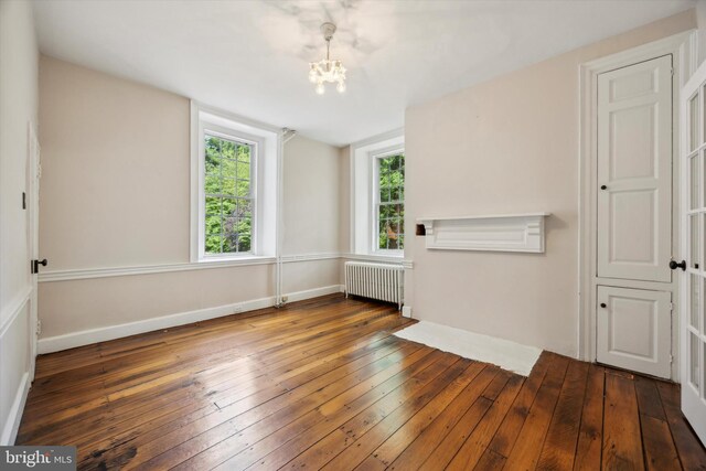 1523 Johnnys Way, West Chester, PA 19382 - unfurnished living room featuring radiator, a chandelier, hardwood / wood-style flooring, and baseboards