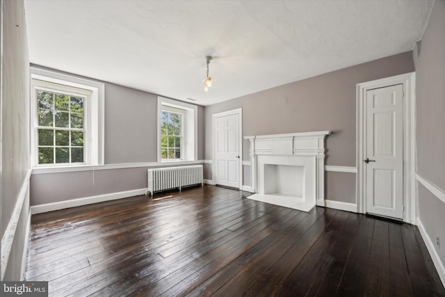 1523 Johnnys Way, West Chester, PA 19382 - unfurnished living room featuring radiator, dark wood-style flooring, baseboards, and a fireplace with flush hearth