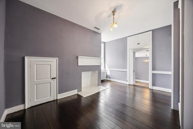 1523 Johnnys Way, West Chester, PA 19382 - unfurnished living room with radiator, hardwood / wood-style flooring, a chandelier, and baseboards