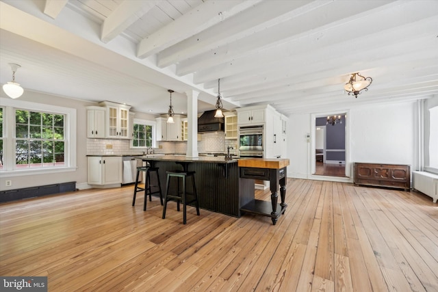 1523 Johnnys Way, West Chester, PA 19382 - kitchen featuring radiator heating unit, a chandelier, beam ceiling, a kitchen breakfast bar, and tasteful backsplash