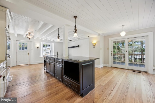 1523 Johnnys Way, West Chester, PA 19382 - kitchen with light wood finished floors, wooden ceiling with exposed beams, a sink, and a center island with sink