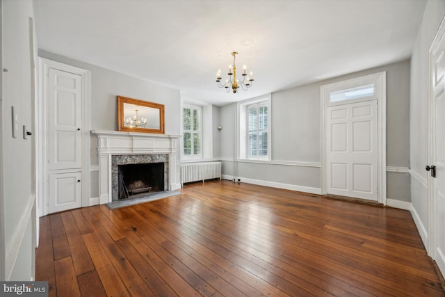 1523 Johnnys Way, West Chester, PA 19382 - unfurnished living room featuring radiator, a chandelier, a premium fireplace, hardwood / wood-style floors, and baseboards