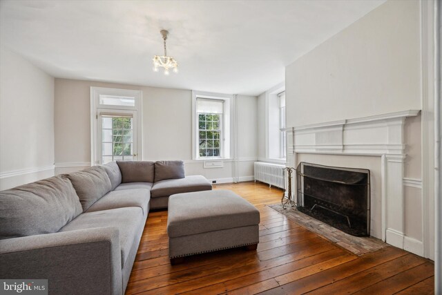 1523 Johnnys Way, West Chester, PA 19382 - living area featuring radiator heating unit, hardwood / wood-style flooring, a fireplace with flush hearth, and a chandelier