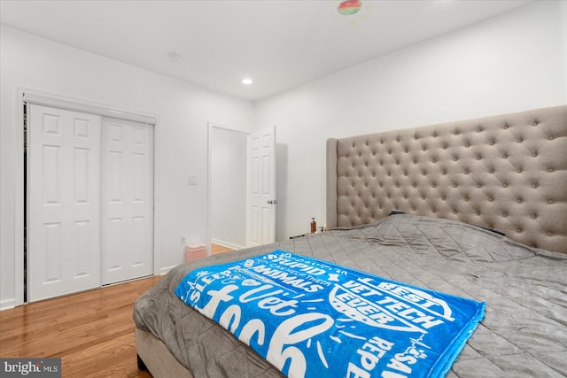 bedroom with hardwood / wood-style floors and a closet