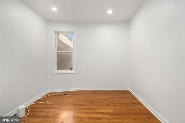 unfurnished room with hardwood / wood-style floors