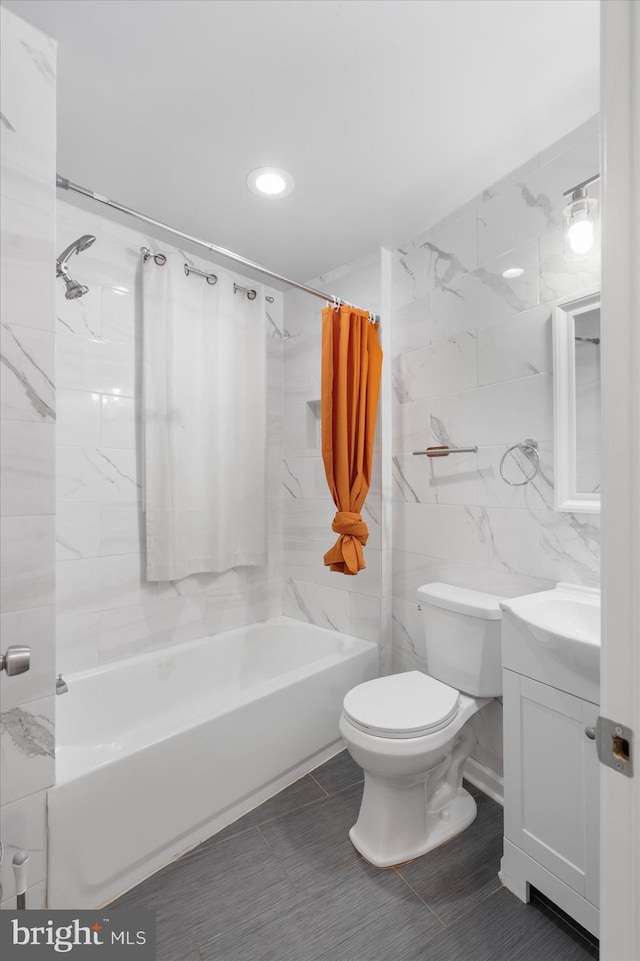 full bathroom featuring tile walls, vanity, shower / bath combination with curtain, and toilet