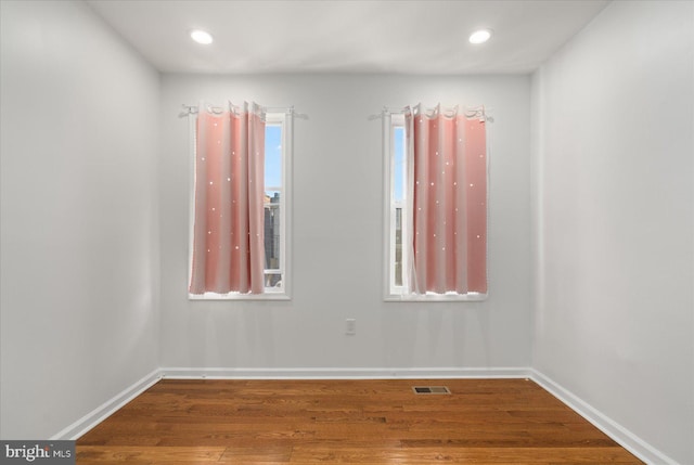 empty room with hardwood / wood-style flooring