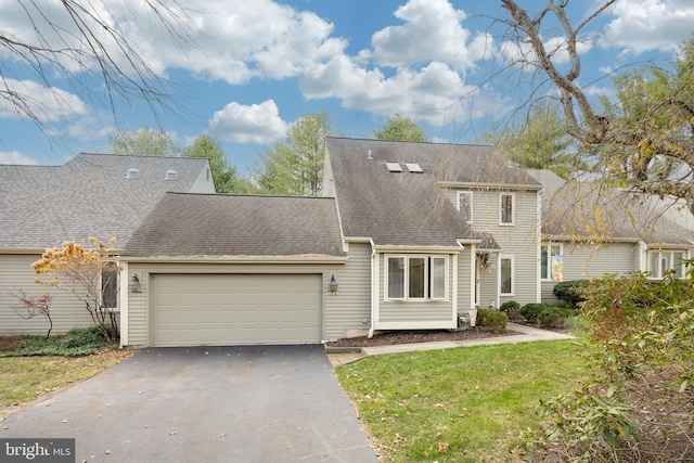 view of front of property featuring a garage and a front yard