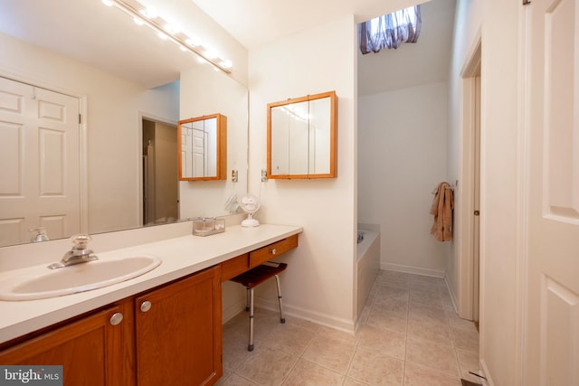 bathroom featuring vanity, tile patterned flooring, and a washtub