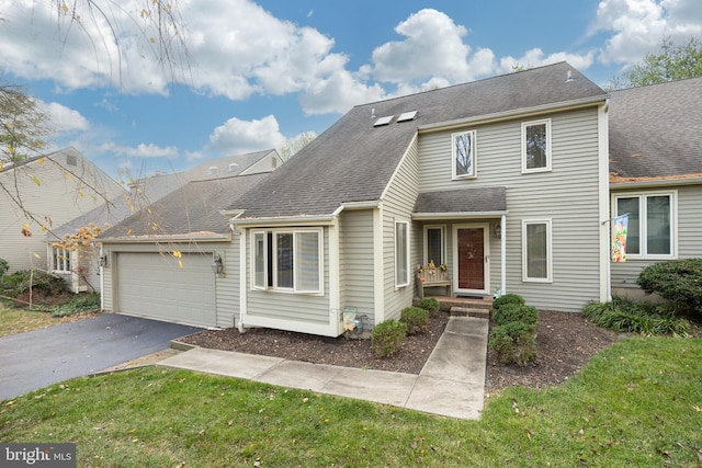 view of front of property featuring a garage and a front yard