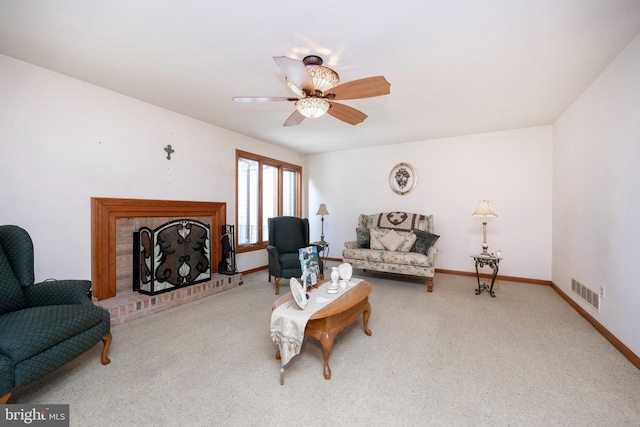 living room featuring a fireplace, ceiling fan, and light carpet