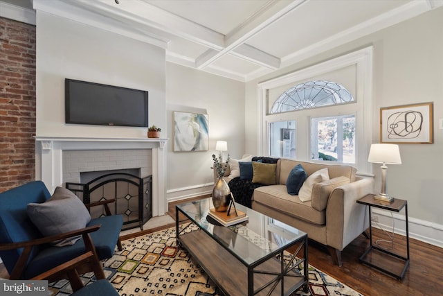 living room featuring ornamental molding, beam ceiling, hardwood / wood-style floors, a fireplace, and coffered ceiling