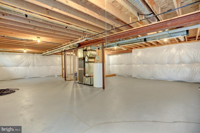 basement featuring heating unit and water heater