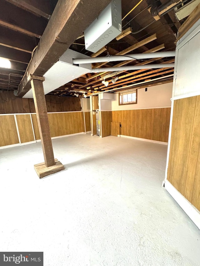 below grade area featuring wood walls and wainscoting