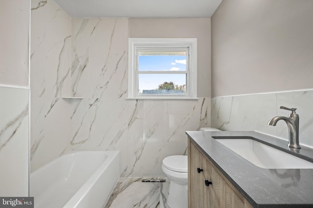 bathroom featuring vanity, a tub to relax in, toilet, and tile walls