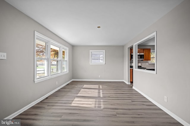 unfurnished room with hardwood / wood-style floors