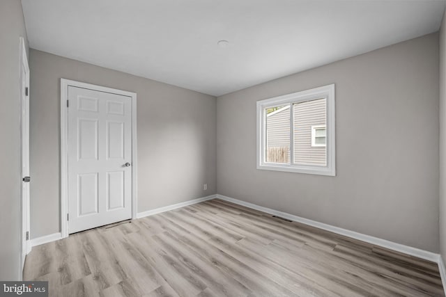 empty room with light hardwood / wood-style floors