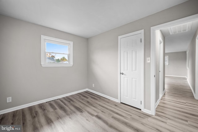 empty room with light hardwood / wood-style flooring