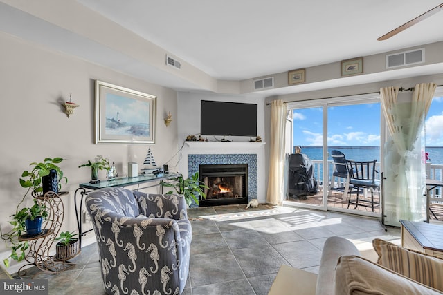 living room featuring a tiled fireplace