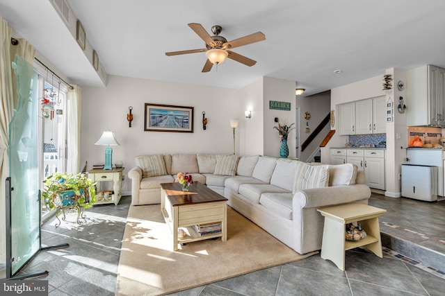 tiled living room with ceiling fan