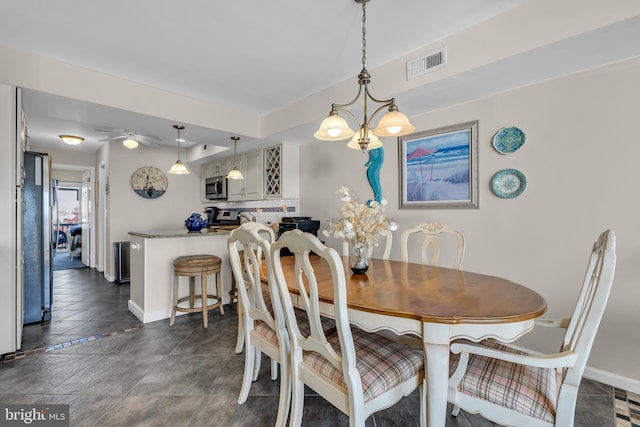 dining space with ceiling fan with notable chandelier