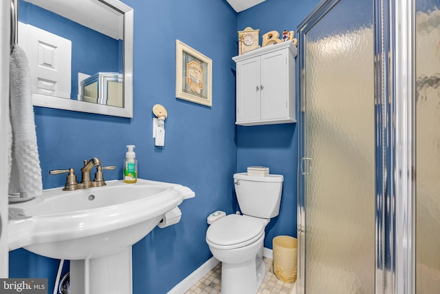 bathroom featuring walk in shower, toilet, and sink