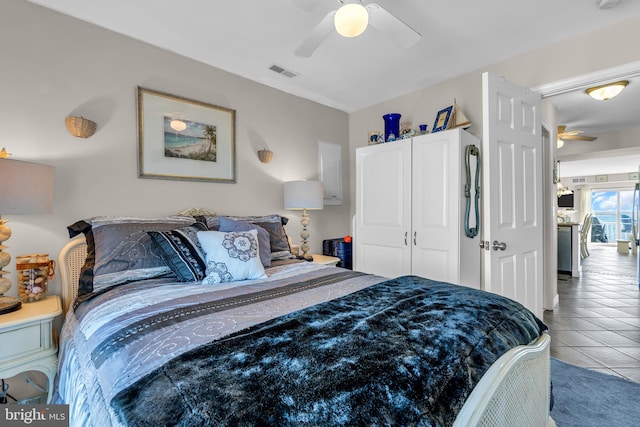 tiled bedroom with a closet and ceiling fan