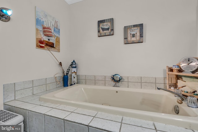 bathroom featuring tiled tub