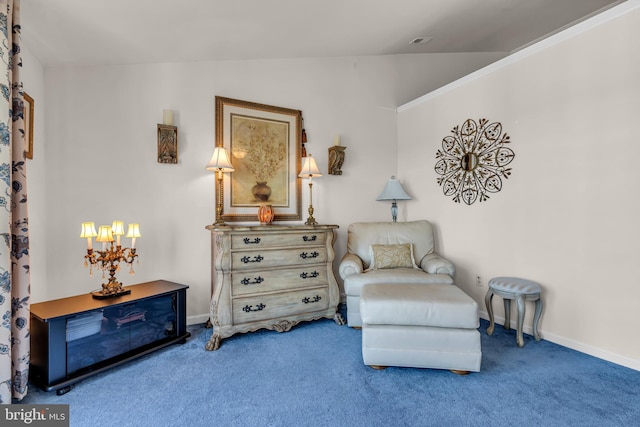 living area featuring a notable chandelier, lofted ceiling, and carpet