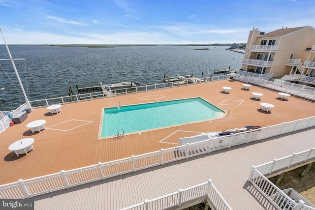 view of swimming pool featuring a water view