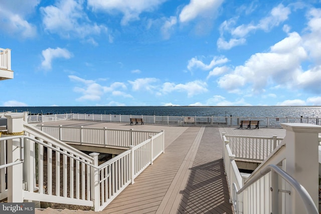 wooden deck featuring a water view