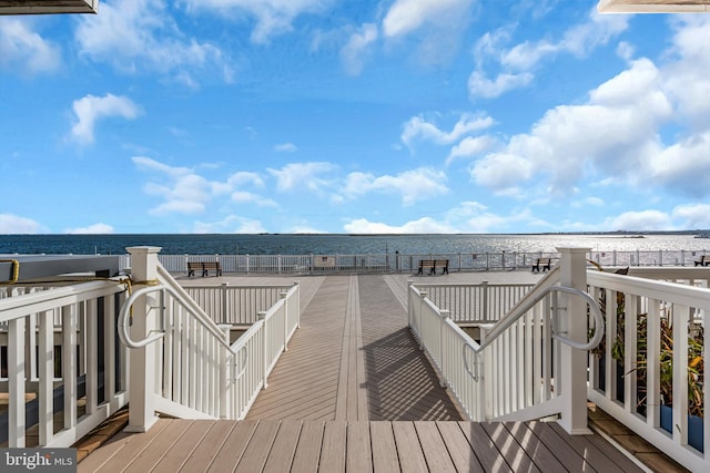 wooden terrace featuring a water view