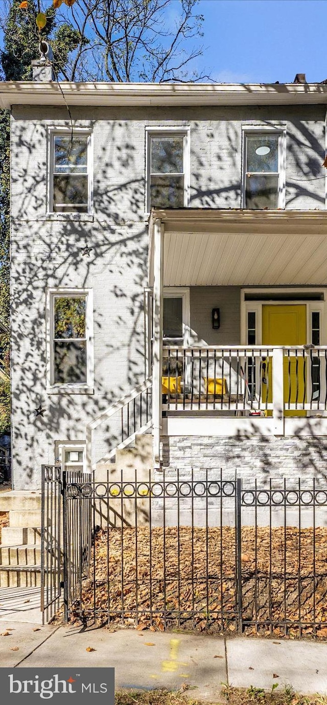 2592 Druid Park Dr, Baltimore, MD 21215 - view of property featuring covered porch and a fenced front yard