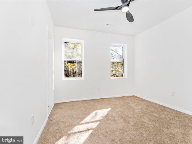 carpeted spare room with ceiling fan