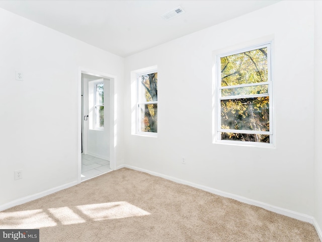 unfurnished room with light colored carpet