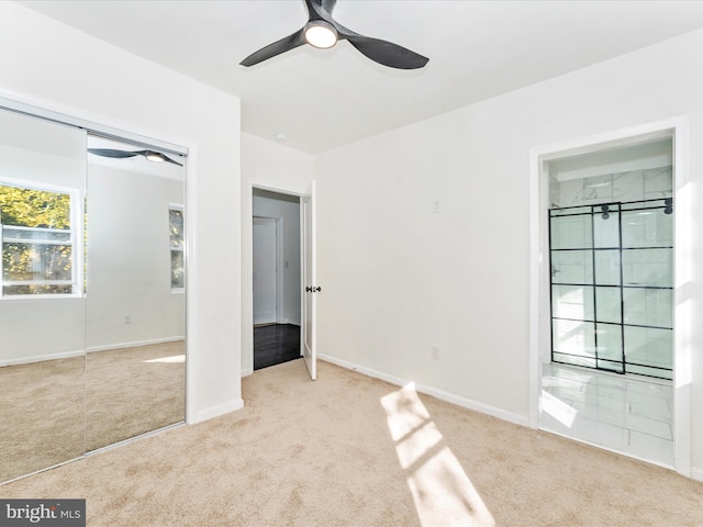 unfurnished bedroom with ceiling fan, a closet, and light colored carpet